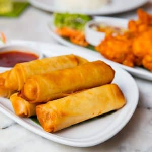https://wok2smile.be/wp-content/uploads/2022/03/spring-rolls-and-fried-chicken-served-in-plates-2021-04-02-20-19-06-utc-min-scaled-1-300x300.jpg